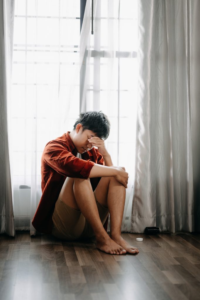 Man sit Depression Dark haired pensive glance Standing by window and anxiety Copy space.