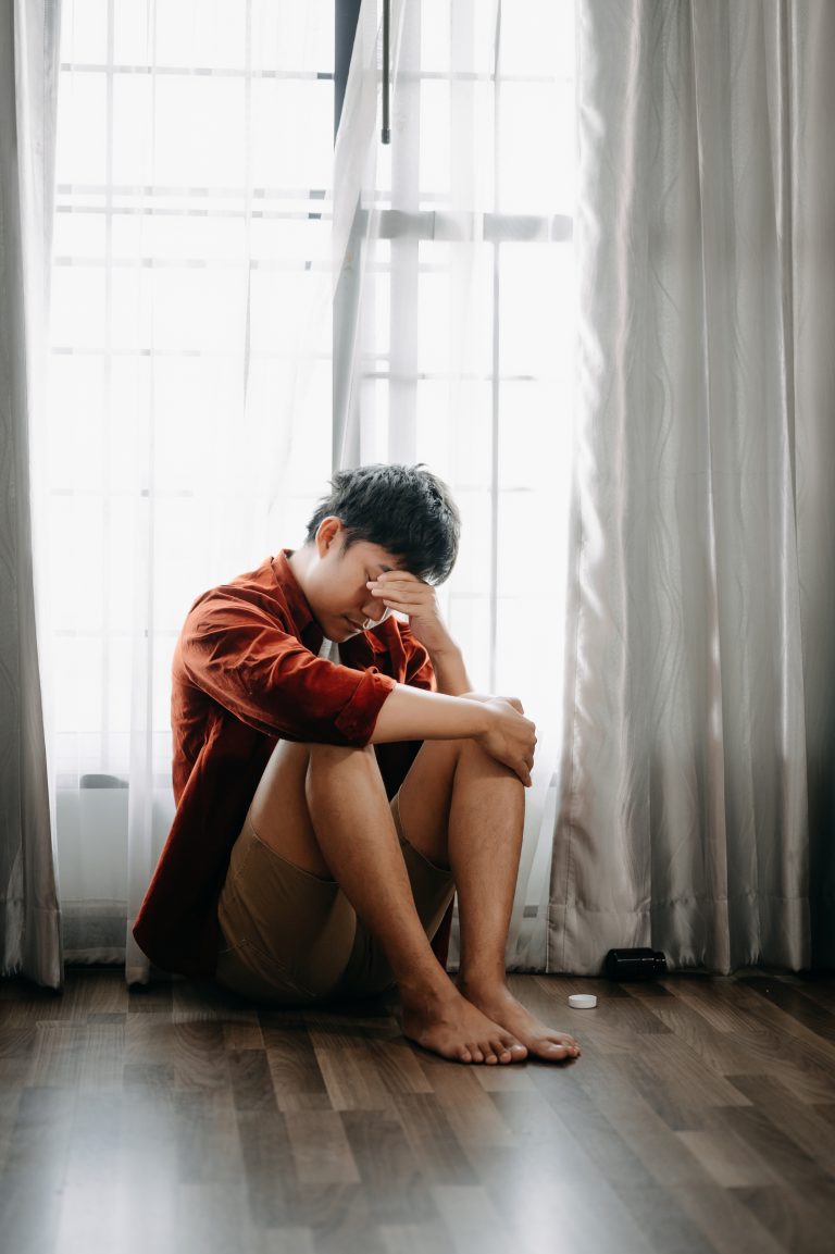 Man sit Depression Dark haired pensive glance Standing by window and anxiety Copy space.